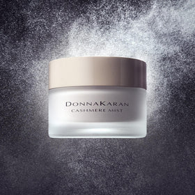 Donna Karan Cashmere Mist crème being dolloped to demonstrate smooth spreadability