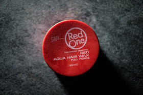 Dorzu Red One beside a coin for scale showing 150ml tub size benefits