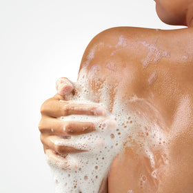 Hand dispensing Dove body wash demonstrating smooth texture and hydrated-skin benefit