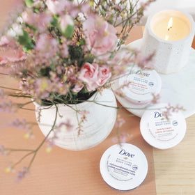 Three Dove travel-size jars in a purse showing convenient on-the-go use
