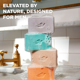Dove Men+Care bar on shower ledge illustrating daily grooming use