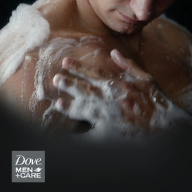 DOVE MEN + CARE bar on shower shelf in active lifestyle setting for refreshed skin