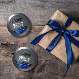 Dove Men+Care beside keys for scale indicating compact size for on-the-go benefit