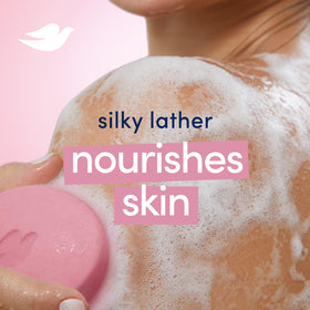 Dove pink bar on shower shelf showing convenient daily body-wash benefit