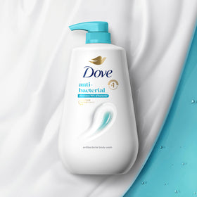 Dove bottle size comparison in hand conveys 30.6 oz capacity benefit