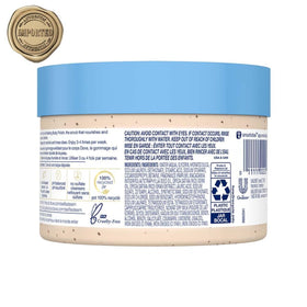 Dove body scrub in hand being applied for smoother hydrated skin