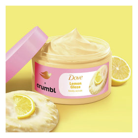 Dove scrub scoop on fingers showing creamy texture and moisturizing benefit