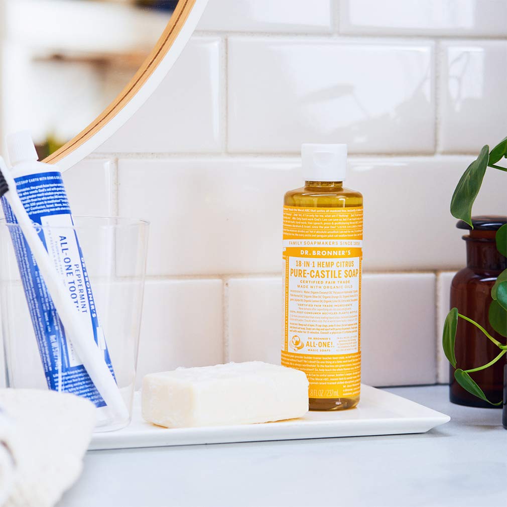 Dr. Bronner's citrus being poured into hand, showcasing concentrated use and economy