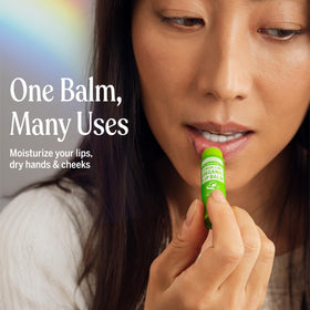 Dr. Bronner's balm in hand being applied to lips demonstrating quick soothing benefit