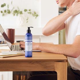 Dr. Bronner's lotion texture in palm demonstrating smooth absorbency and hydration