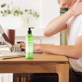 Dr. Bronner's patchouli lime pump being pressed for controlled dispensing and convenience