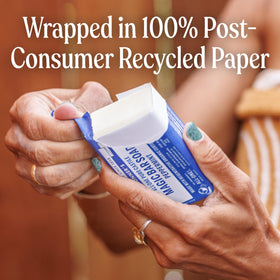 Dr. Bronner's peppermint bar next to hand illustrating 5oz size and easy handling