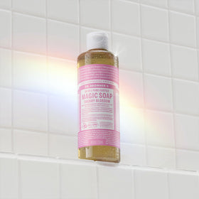 Dr. Bronner's pouring diluted soap to demonstrate concentration and versatility