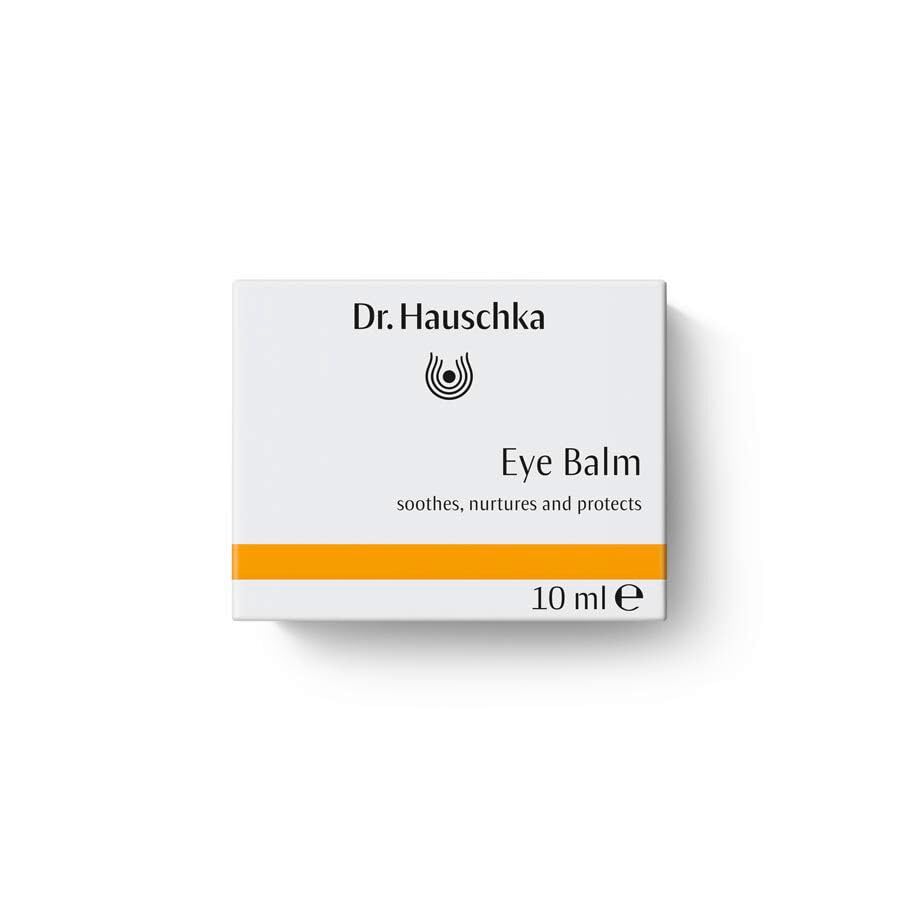 Dr. Hauschka eye balm application on fingertip demonstrating gentle tapping technique for protection