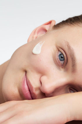 Dr. Hauschka hand applying cream demonstrating gentle skin nourishment