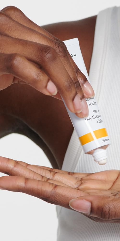 Dr. Hauschka open jar top view revealing pale rose-colored cream