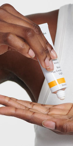 Dr. Hauschka open jar top view revealing pale rose-colored cream