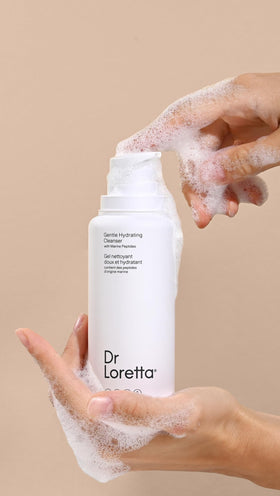 Dr. Loretta bottle in hand for scale, illustrates the 6.76 fl oz travel-ready size