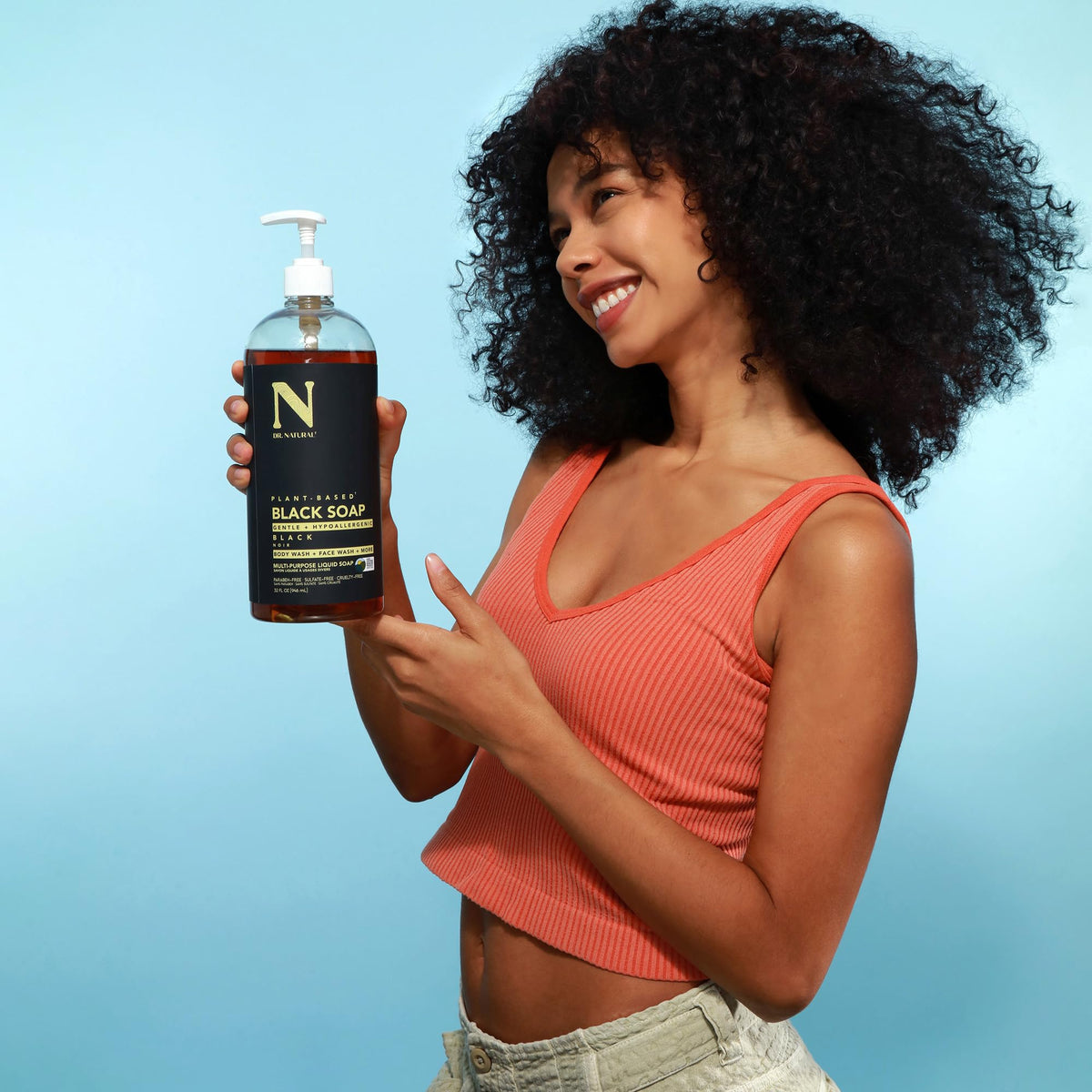 Dr. Natural bottle in shower scene demonstrating versatile body wash use