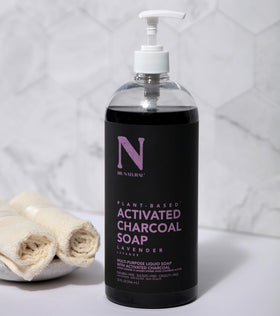 Dr. Natural bottle next to hand for size scale and 32 oz capacity