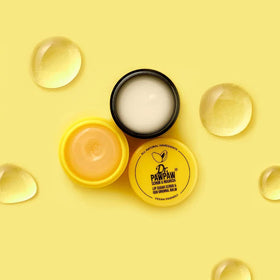 Dr. PAWPAW ORIGINAL BALM next to coin to show compact travel-friendly size benefit