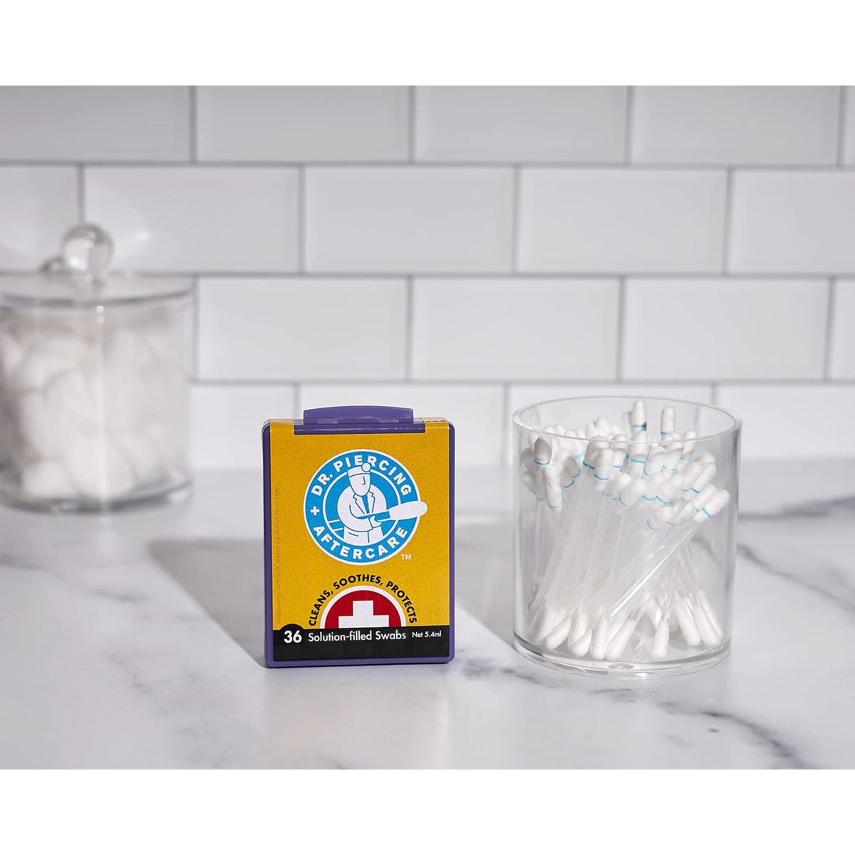 Dr. Piercing Aftercare swab in hand displaying size and travel-friendly scale