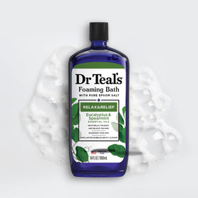 Eucalyptus and spearmint botanicals near Dr Teal's bottle highlighting refreshing scent
