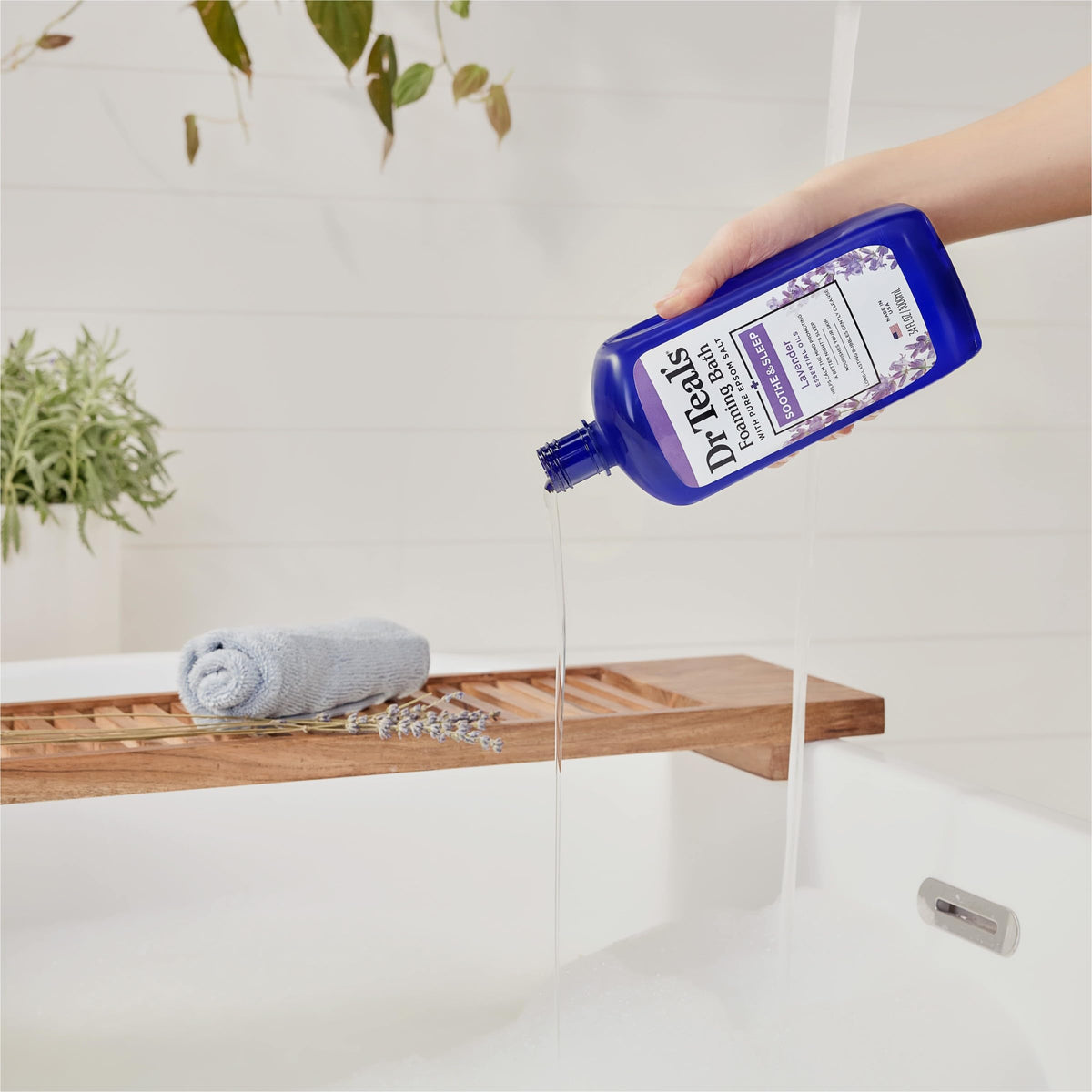 Bottle next to towel demonstrating Dr Teal's size and convenient storage