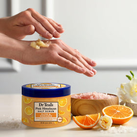 Dr Teal's jar next to hand showing 16 oz scale and travel-ready benefit