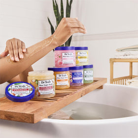 Dr Teal's scrub next to hand showing 19 oz scale and practical size
