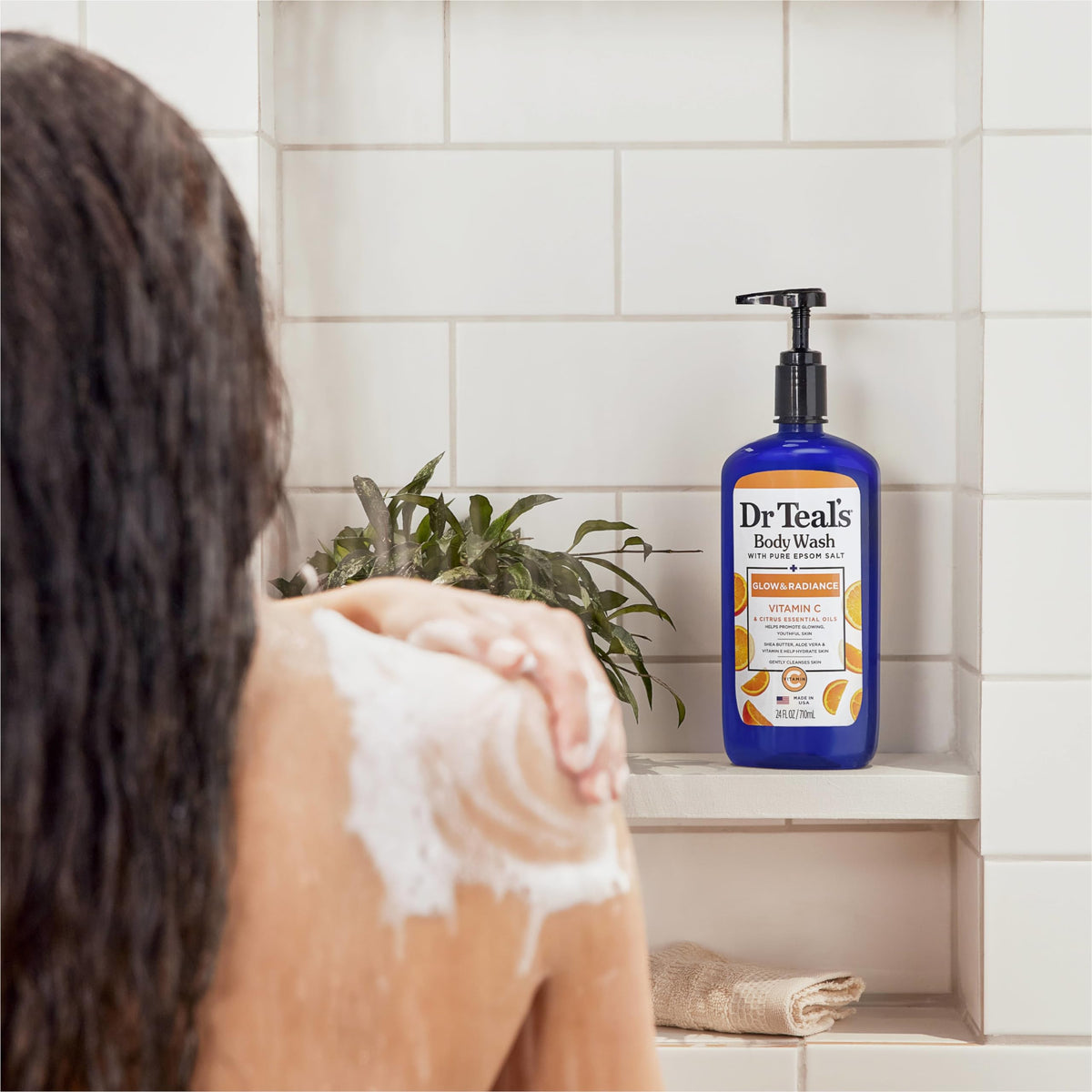 Dr Teal's bottle on shower shelf styled to show everyday bathroom placement and freshness
