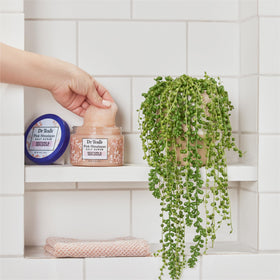 Dr Teal's 16 oz jar next to hand to show actual product size