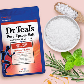 Dr Teal's spa arrangement with towels and bottles, evokes relaxing routine