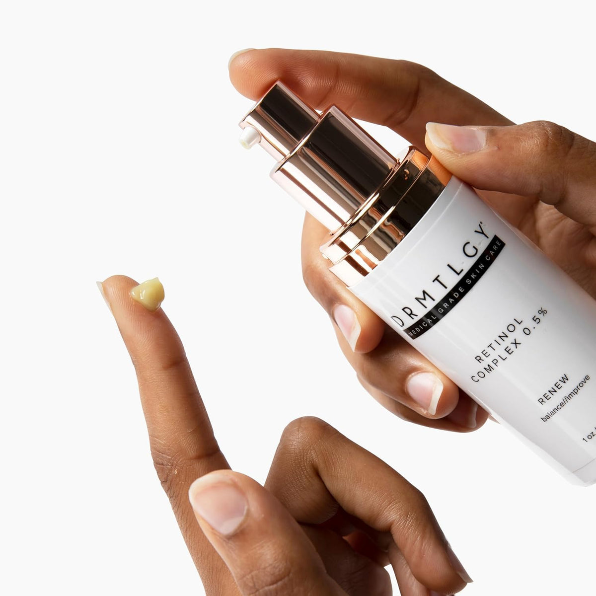 DRMTLGY serum bottle in hand to show compact size and travel-friendly scale