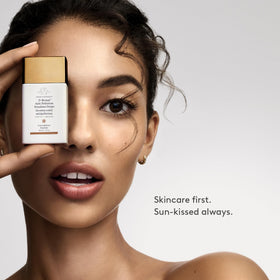 Flatlay of key ingredients with D-Bronzi bottle showing antioxidant and peptide benefit