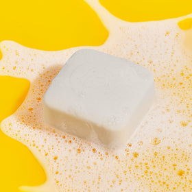 Drunk Elephant Pekee Bar lather in hand demonstrating rich foam and effective cleansing