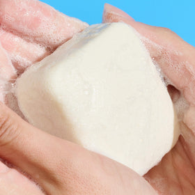 Drunk Elephant Pekee Bar close-up texture shot showing creamy surface and nourishing oils