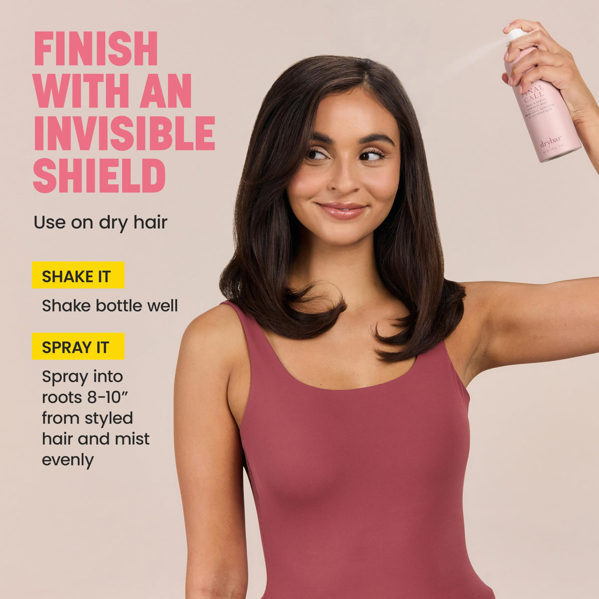 Drybar bottle in hand for scale to show travel-friendly full-size convenience