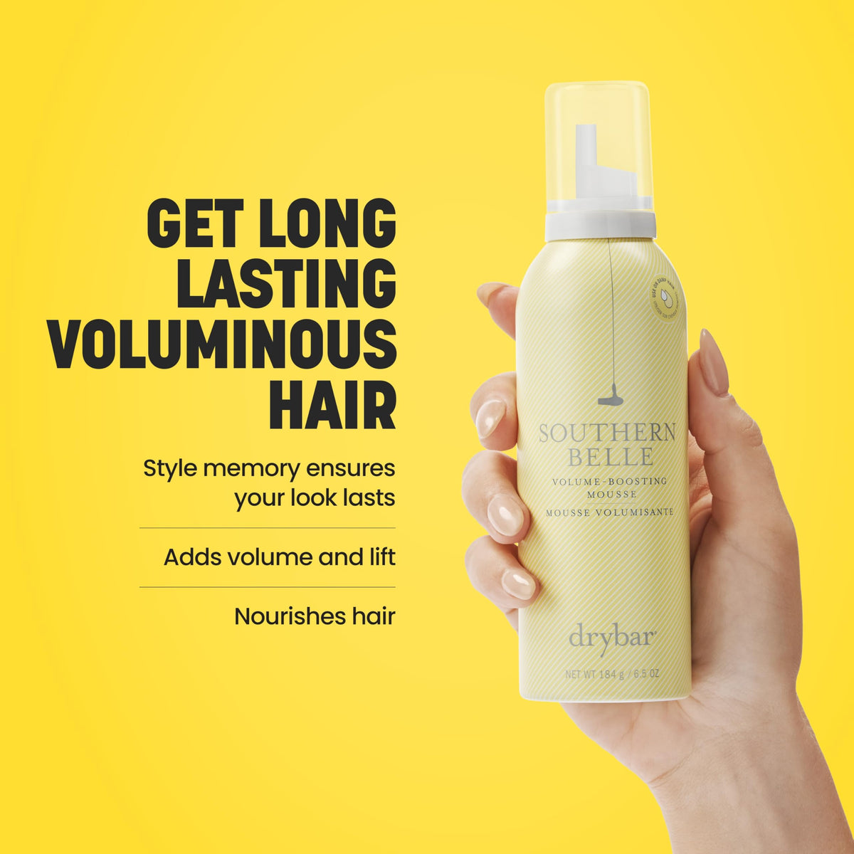 Hand holding Drybar Southern Belle can to show scale and portability