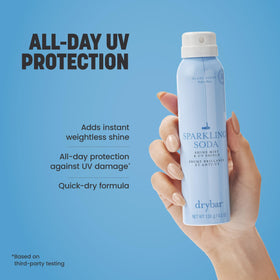 Hand holding Drybar bottle showing size and easy application benefit