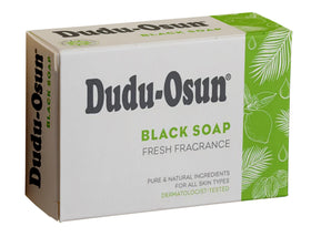 Dudu-Osun bar in hand demonstrating 150g size and travel-friendly convenience