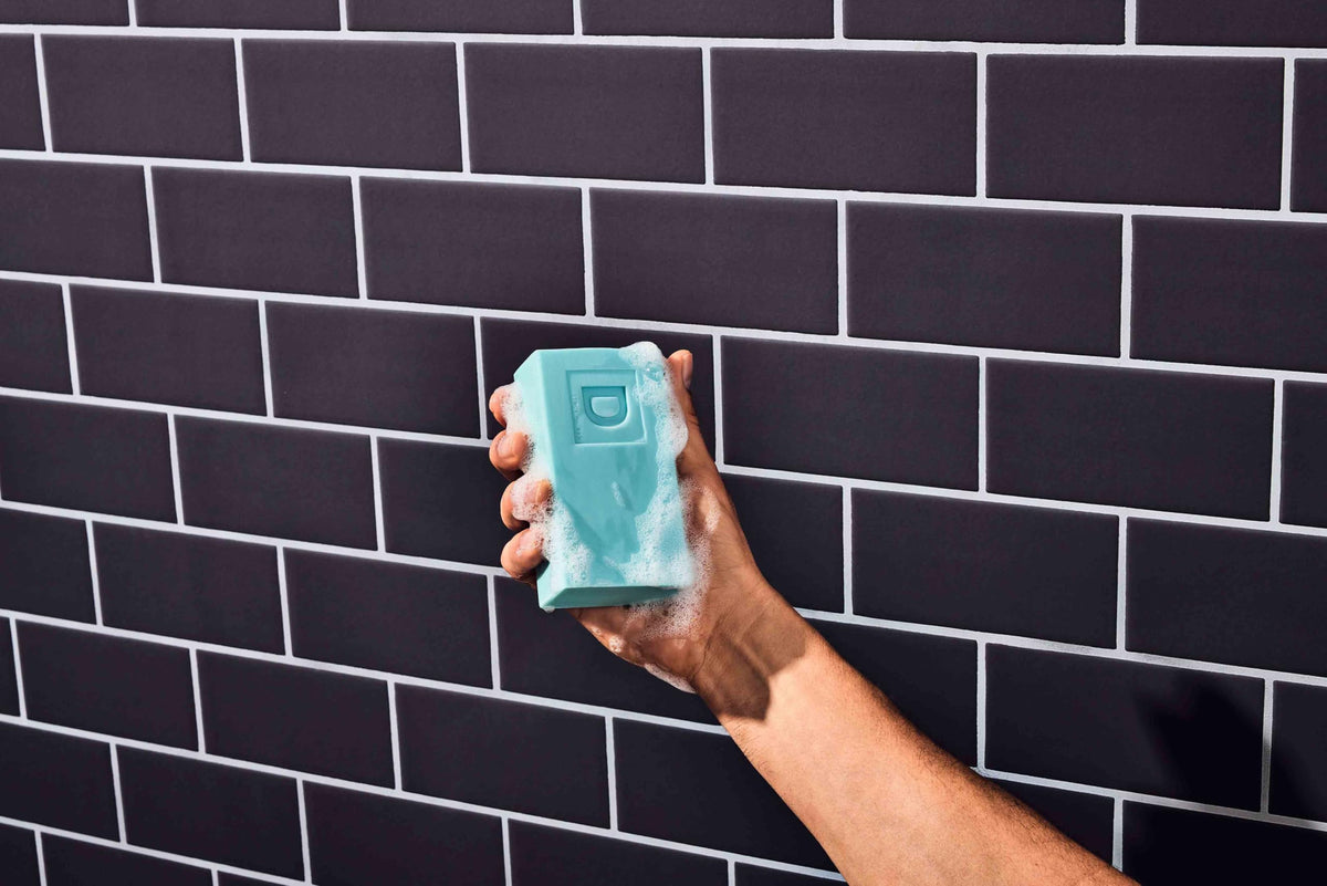 Duke Cannon 10oz bar next to common soap to show bigger, longer-lasting size