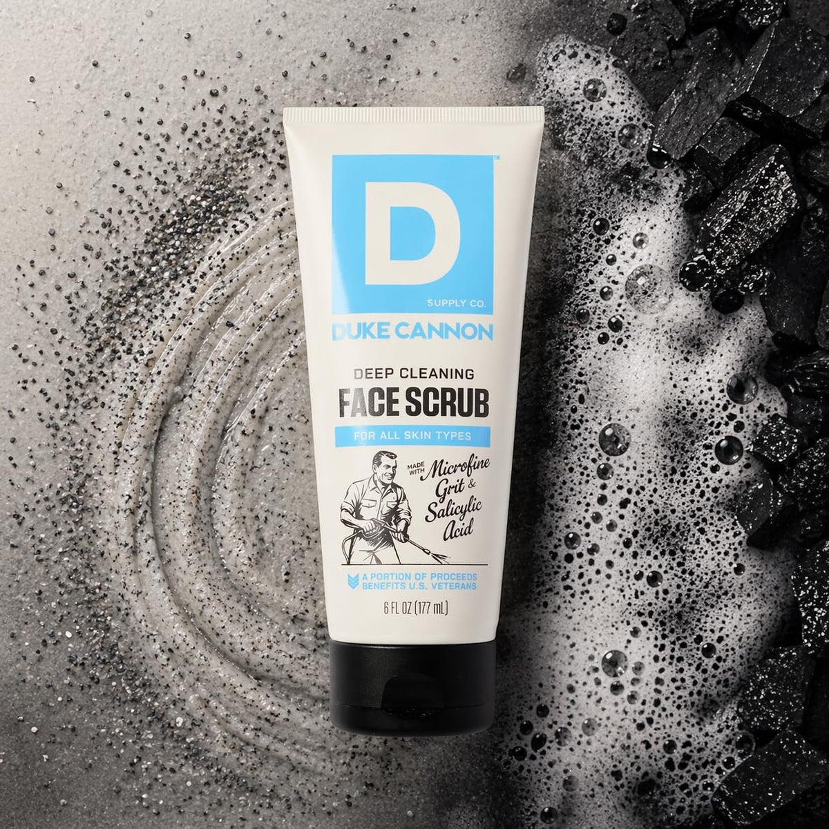 Duke Cannon bottle next to a hand for scale to show portable 6 oz grooming size