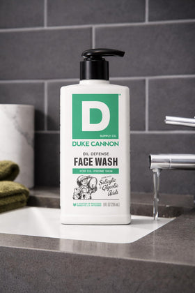 Duke Cannon face wash next to towel in bathroom, illustrating daily routine benefit