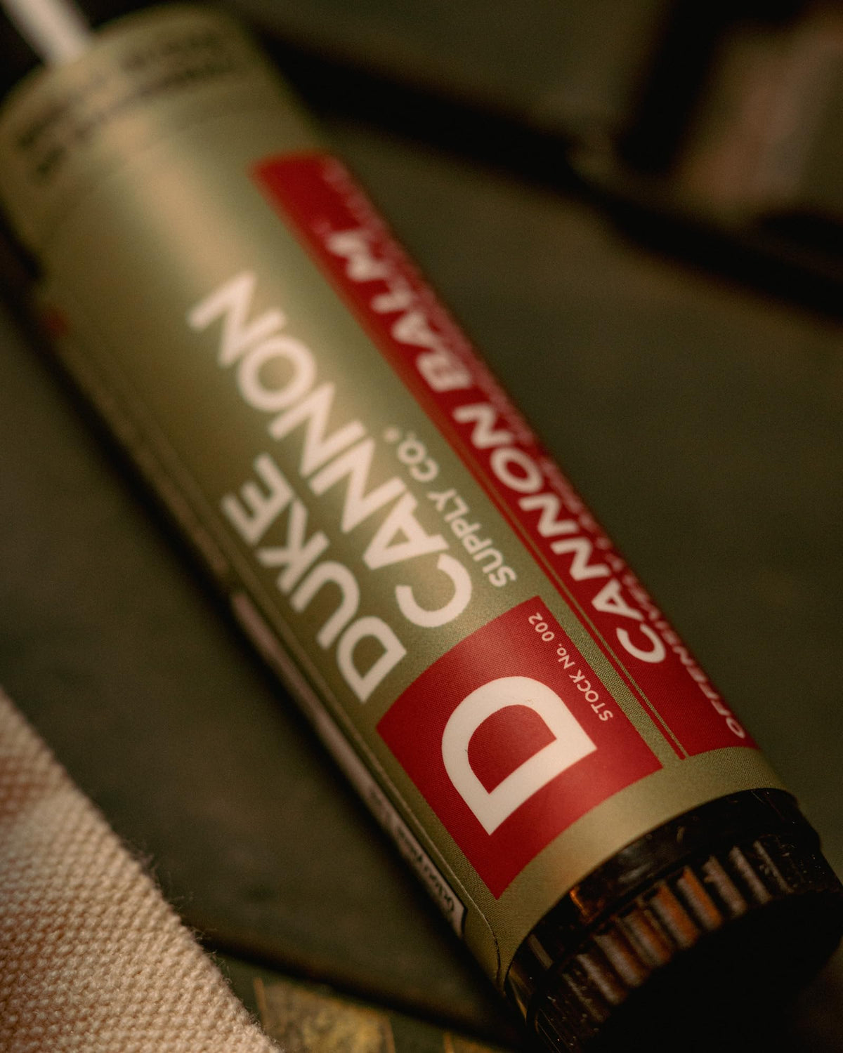Duke Cannon tube in a backpack pocket signaling ready outdoor lip protection