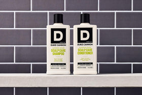 Duke Cannon bottle on bathroom shelf styled to show premium grooming routine benefit