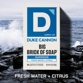 Duke Cannon Naval Diplomacy bar staged on sand evoking ocean-mandarin freshness after outdoor work