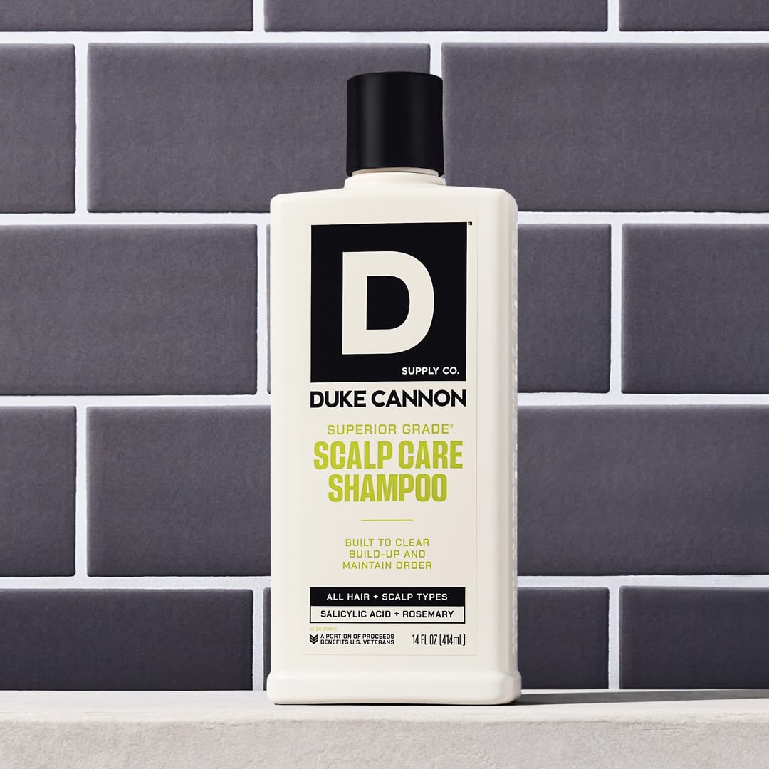 Hand holding 14 oz bottle showing Duke Cannon size and portability