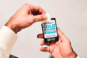Duke Cannon scale comparison beside a hand showing compact size for travel convenience