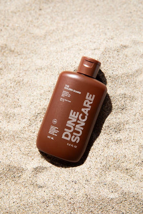 DUNE Golden Guard in beach setting illustrating reef-safe outdoor protection